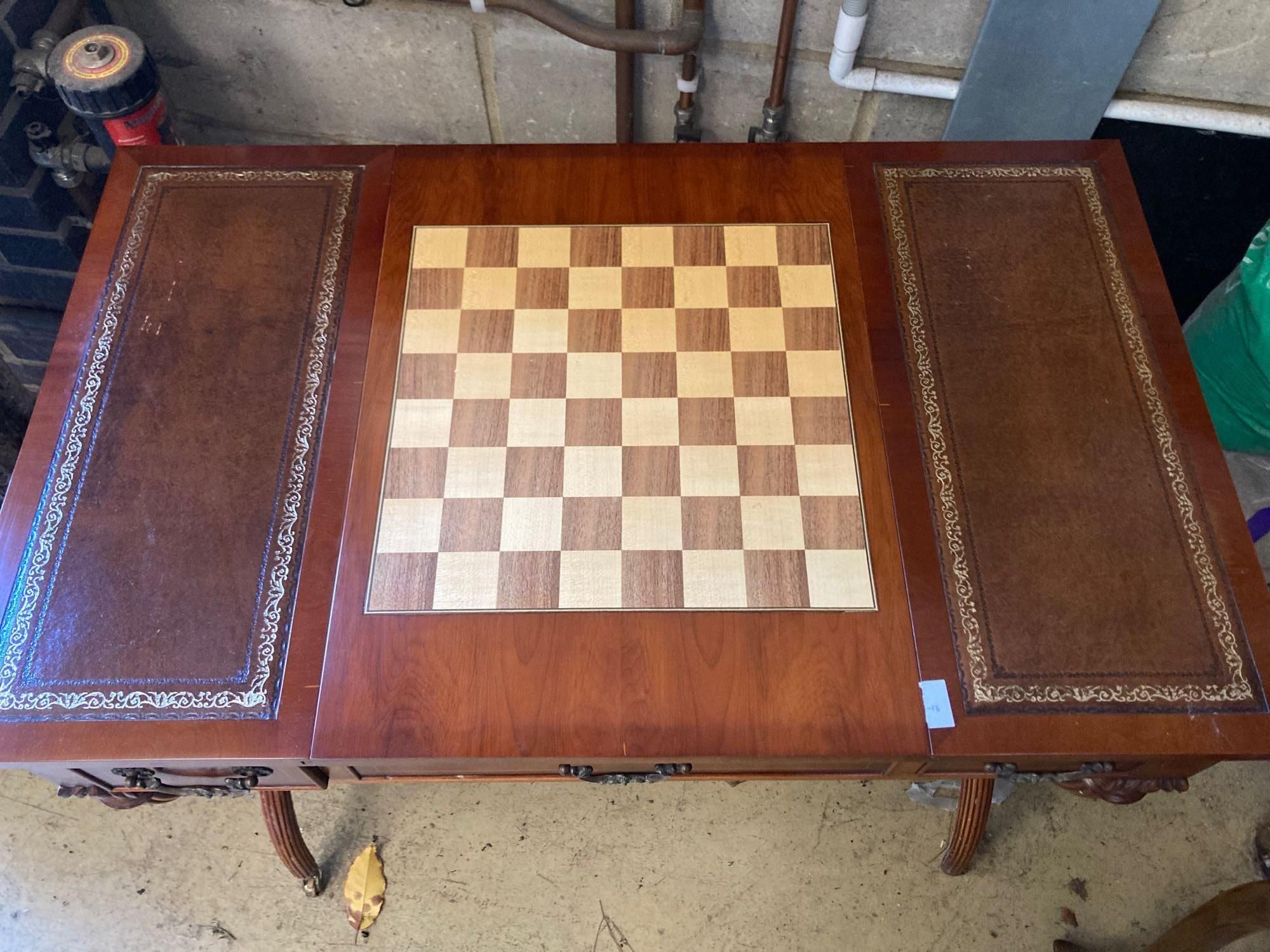 A modern yew wood and mahogany writing table, with sliding backgammon and chessboard top, width 92cm